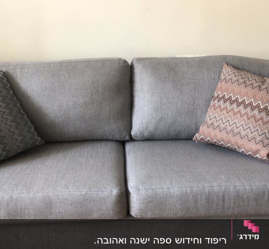 ספה אפורה עם כריות דקורטיביות בזיגזג